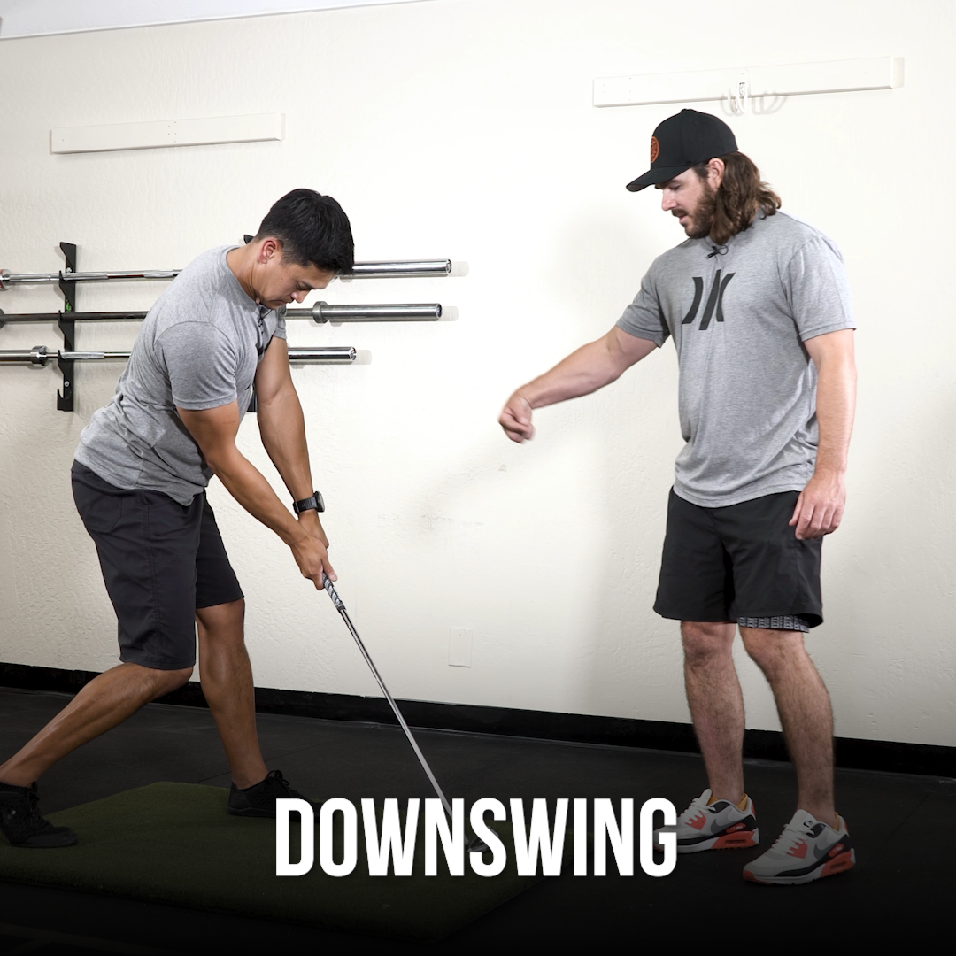 Man swinging a golf club showing the downswing.