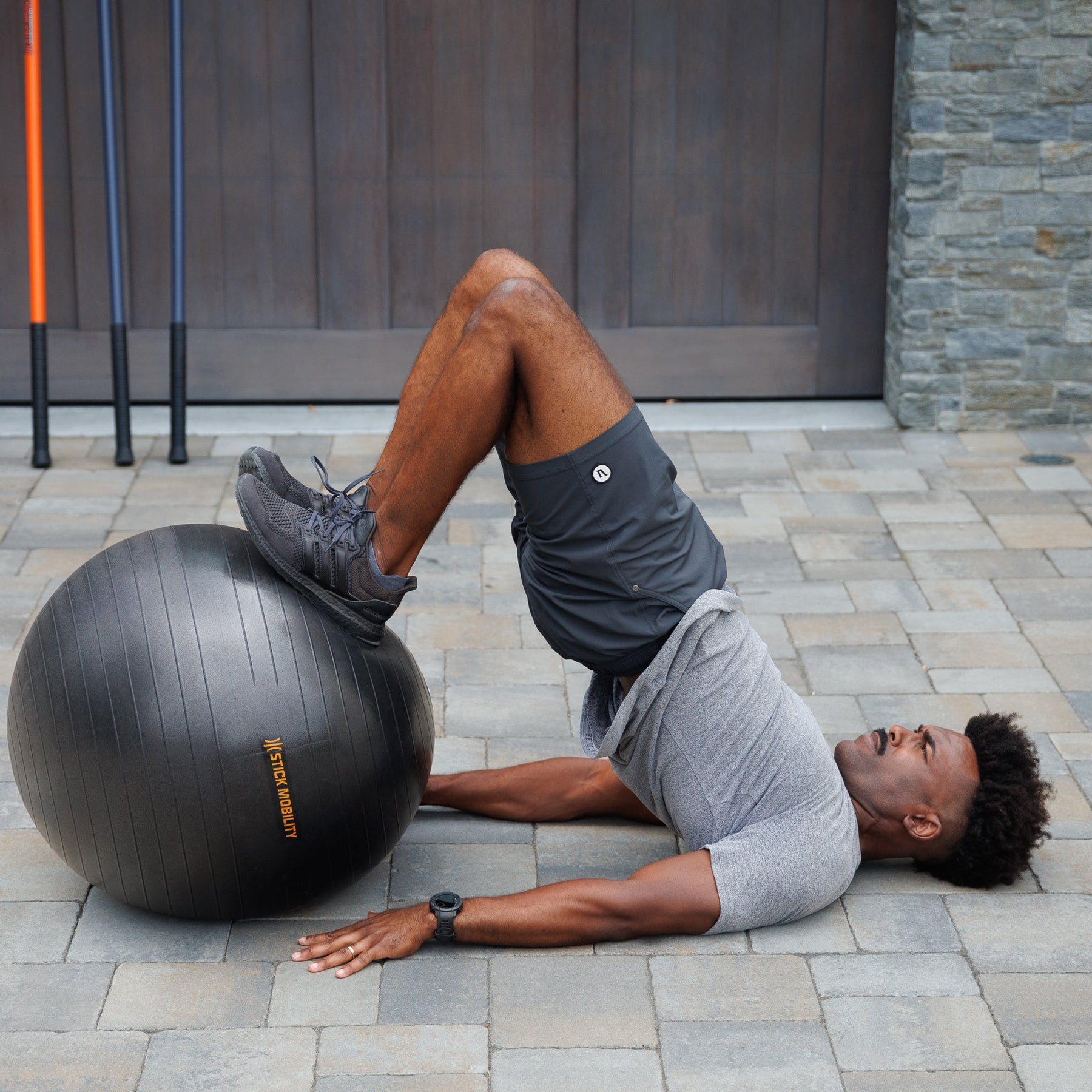 Man performing a hip bridge with an Exercise Ball
