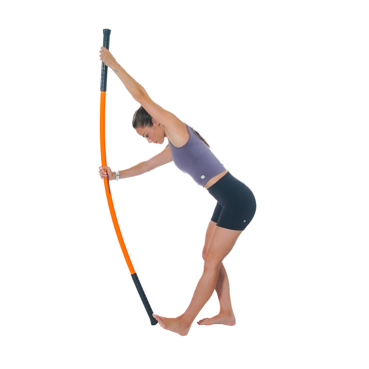 A woman performing an exercise using a Training Stick.
