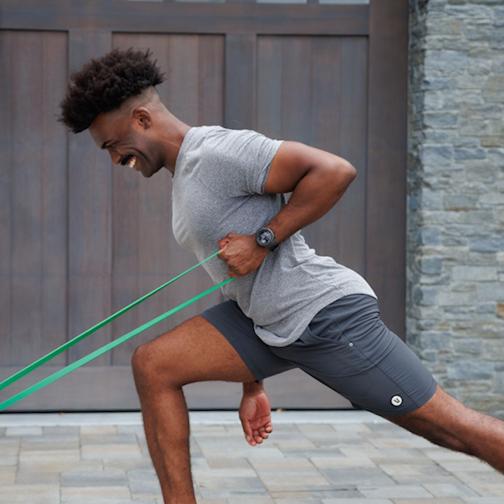 Man performing a rowing movement with the Stick Mobility Resistance Band