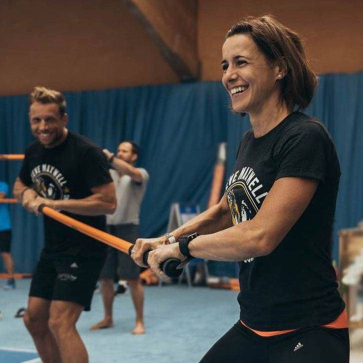 Man and woman holding each end of a training stick.