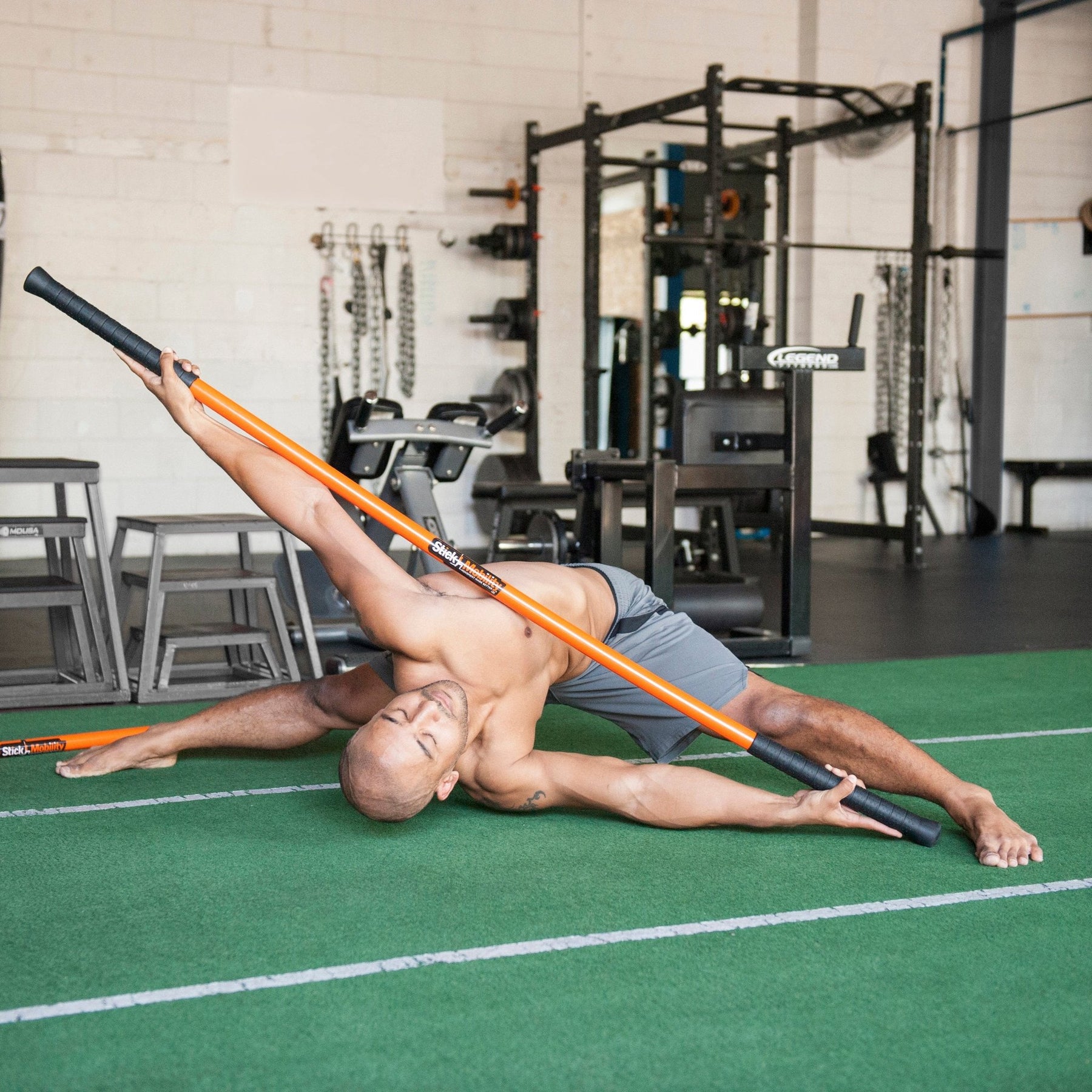 Man performing the Stick Mobility slapshot with a training stick