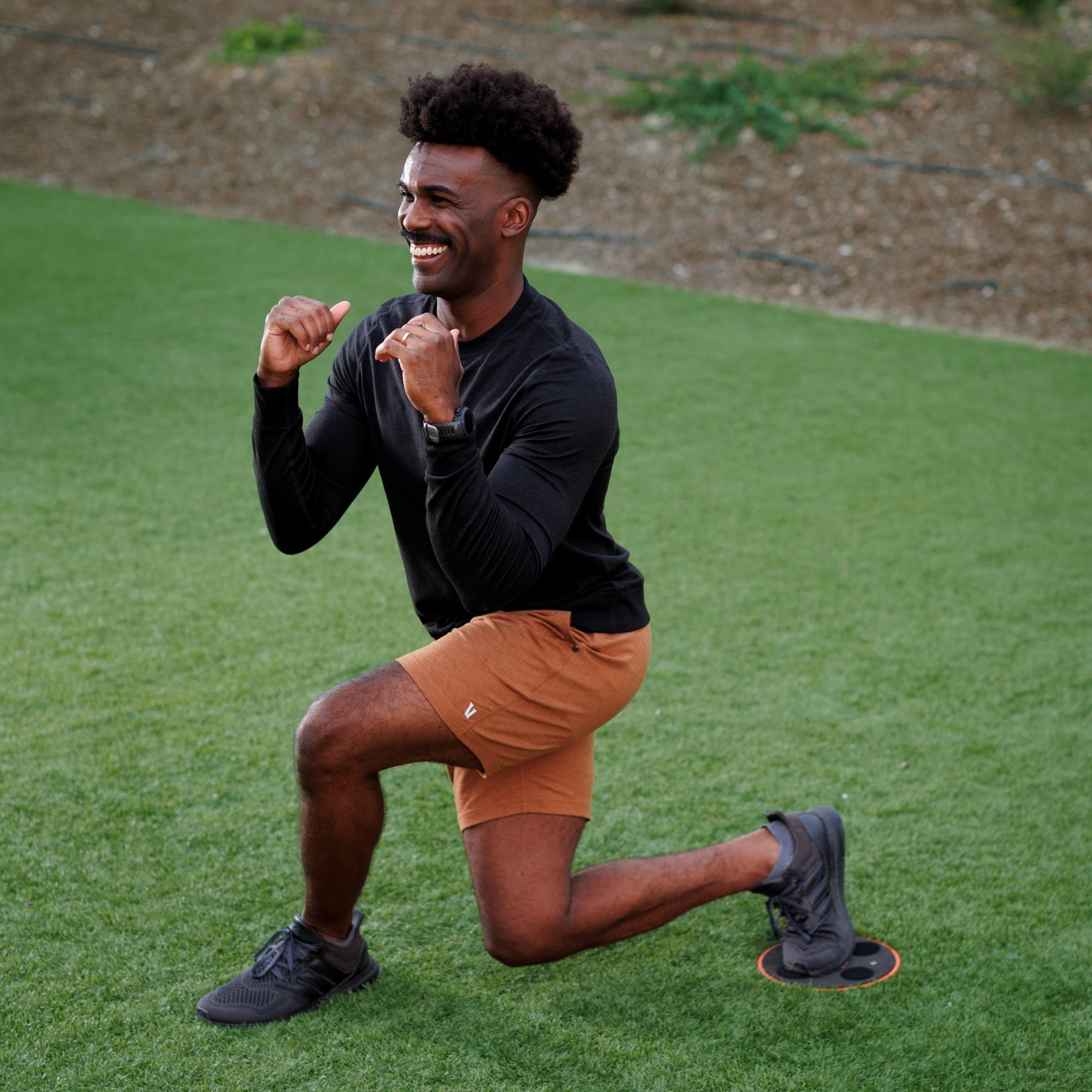 Man smiling while in a lunge with TriSlider under foot