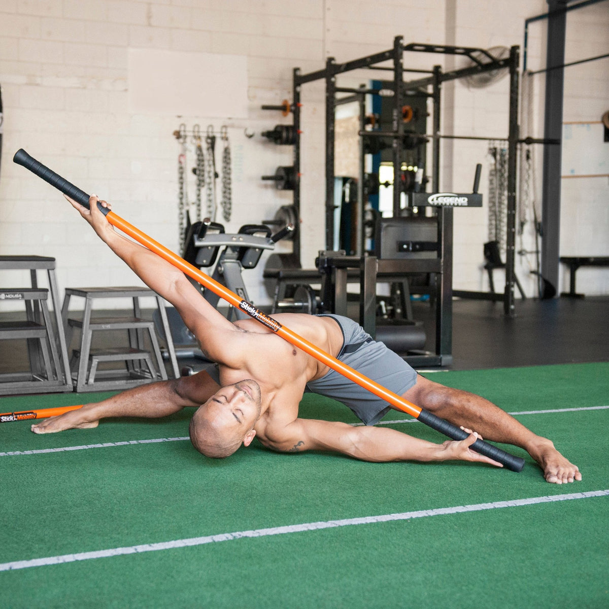 Man performing the Stick Mobility slapshot with a training stick